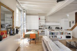 a living room with a couch and a table at Cosy appart Odéon Saint Germain in Paris