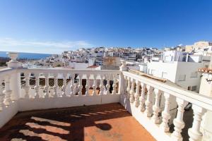 a balcony with a view of a city at RentitSpain Casa Abanico a pasos de Castillo de Salobreña in Salobreña