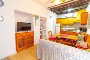 a kitchen and dining room with a table and a dining room at RentitSpain Casa Abanico a pasos de Castillo de Salobreña in Salobreña +10 photos