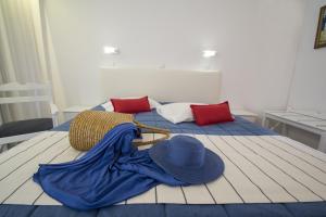 a bed with two beds with hats on it at Kordistos Hotel in Kefalos