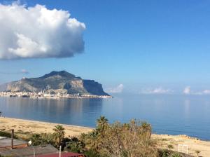 a view of the ocean with a mountain in the background at Palazzo Scavone in Palermo