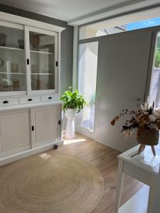 a living room with white cabinets and a table at Löftchen in Roetgen