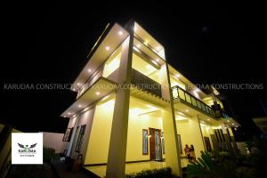 a building with lights on it at night at Sai Residence in Jaffna
