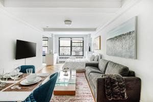 a living room with a couch and a table at Cozy Studio Apartment in New York