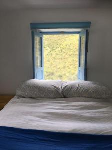 - un lit en face d'une fenêtre avec un couvre-lit dans l'établissement The Tack Room (Former Stables), à Rubite