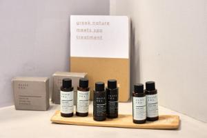 a group of four bottles of hair products on a wooden shelf at Amorgion Village in Katapola