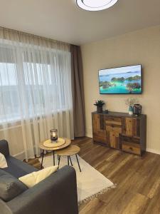A television and/or entertainment centre at Vienibas Apartaments