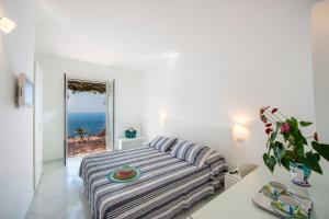 a bedroom with a bed and a view of the ocean at Il Barilotto in Positano