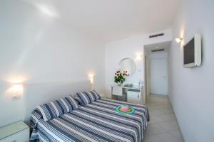 a living room with a bed and a television at Il Barilotto in Positano