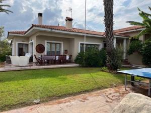 une maison avec une table de ping-pong dans la cour dans l'établissement Akamas Bay View Villa, à Pólis Chrysochoús