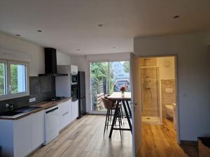 a kitchen with a table in the middle of a room at Ness'house in Tregueux