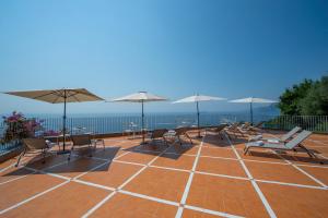 a group of chairs and umbrellas on a patio at Il Barilotto in Positano