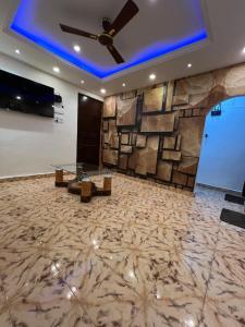 a lobby with a ceiling fan and a stone wall at Casa sportsman Appament in Calangute