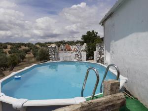 a large blue swimming pool on the side of a building at Alojamiento Rural Las Viñas in Torredonjimeno