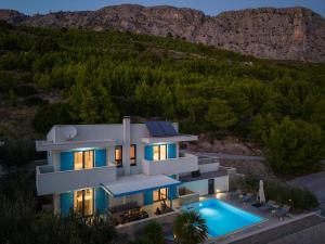 an aerial view of a house with a swimming pool at Villa Allegra with 32msq heated pool, 300m far from sandy beaches, open sea view in Omiš