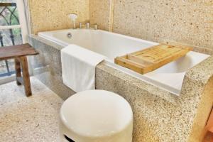 a bathroom with a toilet and a bath tub at Aurora Phu Quoc Hotel & Cafe in Phu Quoc