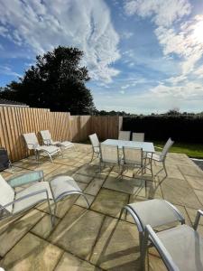 a patio with a table and chairs and a fence at The Ridge Bungalow, at the highest point in the Heart of Cheshire in Frodsham