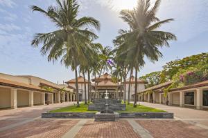 a courtyard with palm trees and a fountain at Resort Villa Da Nang Luxurious Abogo in Da Nang