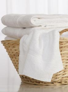 a basket filled with white towels on a table at Bond Street Mayfair Penthouse in London