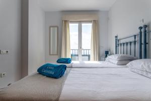 two twin beds in a bedroom with a window at Casa de Carolina in Frigiliana +22 photos