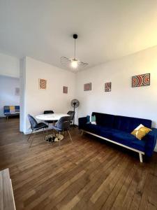 sala de estar con sofá azul y mesa en Appartement Saphir - 3 pers. - Sedan, en Sedan