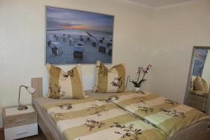 a bedroom with a bed with a picture on the wall at Befeld Susanne in Neustadt in Holstein