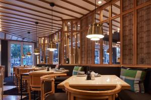 a restaurant with tables and chairs and windows at Central Hotel Münster in Münster