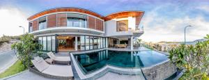 a large house with a swimming pool in front of it at Promotion Early Booker Corner Villa 5 Bedrooms infinity Pool & BBQ Outdoor in Nha Trang