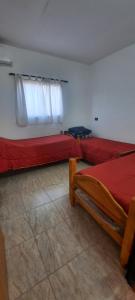 a room with two beds and a window at RUKA Apart in Chilecito