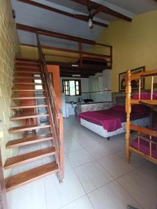 a bedroom with a bunk bed and a staircase at Chale Cantão de Itamambuca in Ubatuba