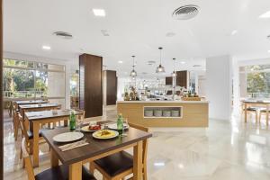 eine Küche und ein Esszimmer mit Tisch und Stühlen in der Unterkunft Hotel Pabisa Sofia in Playa de Palma