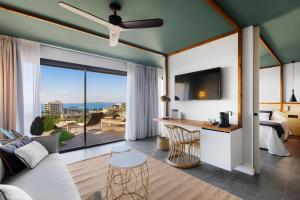 a living room with a bed and a large window at Aubamar Suites & Spa in Playa de Palma
