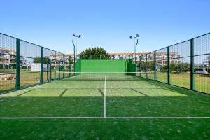 a tennis court with a net and lights on it at Panorámica Golf Resort in Sant Jordi