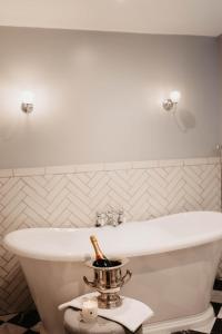a bathroom with a toilet and a bowl on top of it at The Boar's Head in Harrogate
