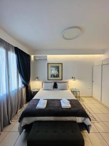 een slaapkamer met een groot bed en 2 handdoeken bij Gianna’s apartment central Aigio Cozy and Shining in Aigio