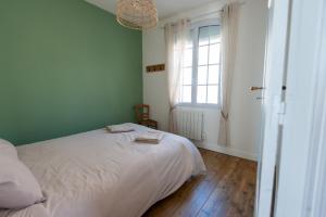 Cama ou camas em um quarto em La Préférée, app vue mer à Ault