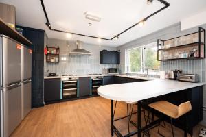 a kitchen with a white counter and a table at Queens's University Elms BT9 in Belfast