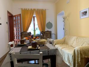 a living room with a table and a couch at Bouganville in Viverone