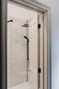 a glass shower door in a bathroom at The Boar's Head in Harrogate