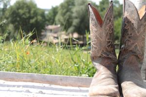 a pair of cowboy boots sitting on a fence at Radius Horse Ranch B&B in Massa Martana +73 photos
