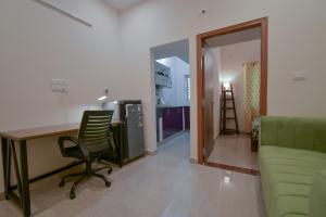 an office with a desk and a chair and a room at HomeSlice Manzil - 1BHK in HSR in Bangalore