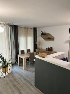 a kitchen and dining room with a table and chairs at Sa Palometa in Tossa de Mar