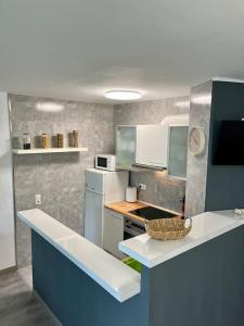 a kitchen with a blue and white counter top at Sa Palometa in Tossa de Mar