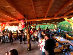 a group of people standing around in a restaurant at Pensiunea Alexia in Petroşani