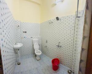 a bathroom with a toilet and a sink at RN Residency in Varanasi