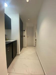 a hallway of a room with a white floor at Studio Unit in Ashdod Israel in Ashdod