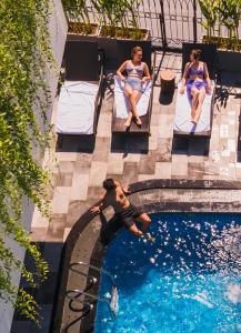 a group of people sitting in chairs in a swimming pool at Aaron Boutique Hotel in Nha Trang