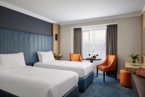 a hotel room with two beds and a desk at Springfield Hotel in Leixlip +35 photos
