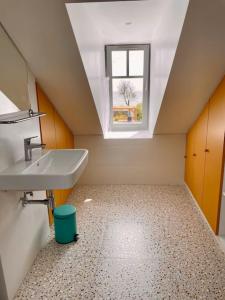 uma casa de banho no sótão com um lavatório e uma janela em Face Mer Villa Le Petit Breton em Pornichet