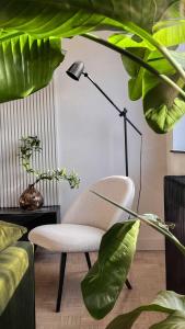 a living room with a chair and a lamp at ZEST Verde in Kragujevac